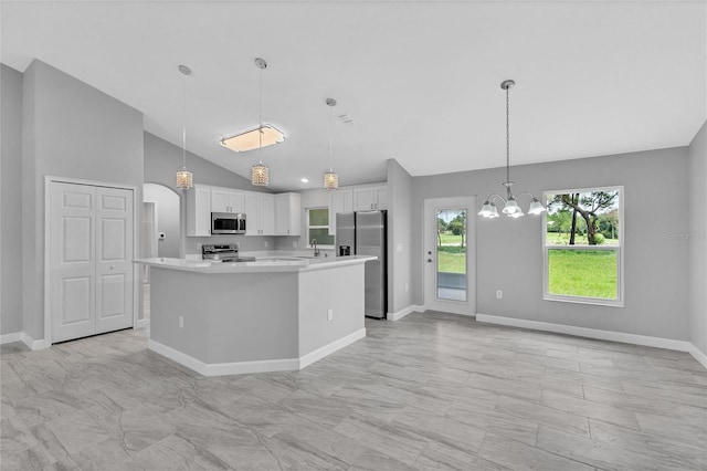 1329 N Old Mill Dr, Deltona, FL 32725 - kitchen with a notable chandelier, a center island, stainless steel appliances, white cabinets, and light countertops