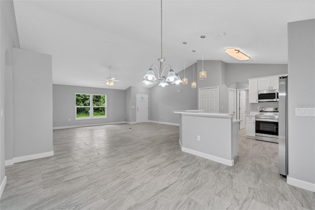 1329 N Old Mill Dr, Deltona, FL 32725 - kitchen featuring arched walkways, stainless steel appliances, light countertops, white cabinetry, and decorative light fixtures
