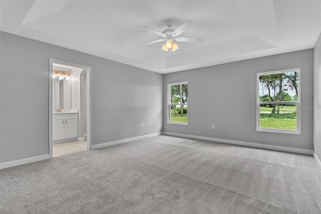 1329 N Old Mill Dr, Deltona, FL 32725 - spare room with light colored carpet, baseboards, a tray ceiling, and a ceiling fan