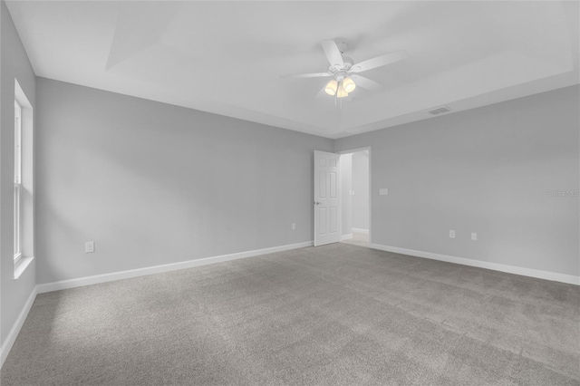 1329 N Old Mill Dr, Deltona, FL 32725 - unfurnished room with visible vents, ceiling fan, baseboards, carpet floors, and a raised ceiling