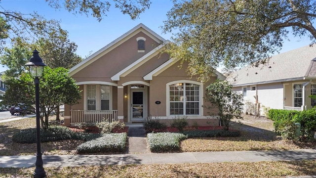 view of front of house with stucco siding and a porch