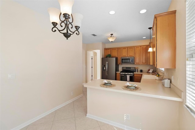 kitchen featuring visible vents, light countertops, appliances with stainless steel finishes, a peninsula, and a sink