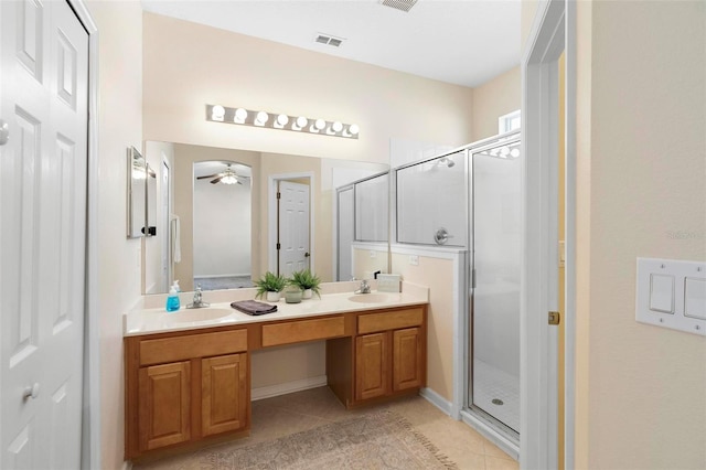 bathroom featuring a sink, visible vents, double vanity, and a shower stall