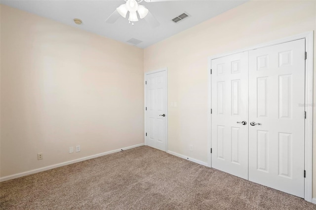 unfurnished bedroom featuring visible vents, baseboards, carpet floors, a closet, and a ceiling fan