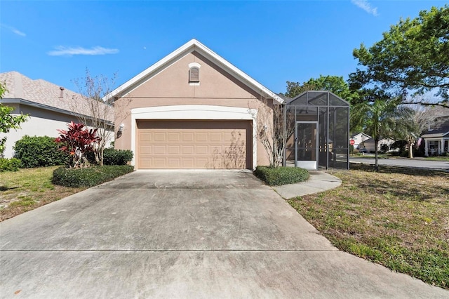 view of front of property with an attached garage, driveway, and stucco siding