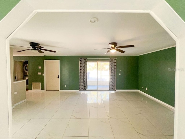 unfurnished room featuring a ceiling fan, marble finish floor, and baseboards