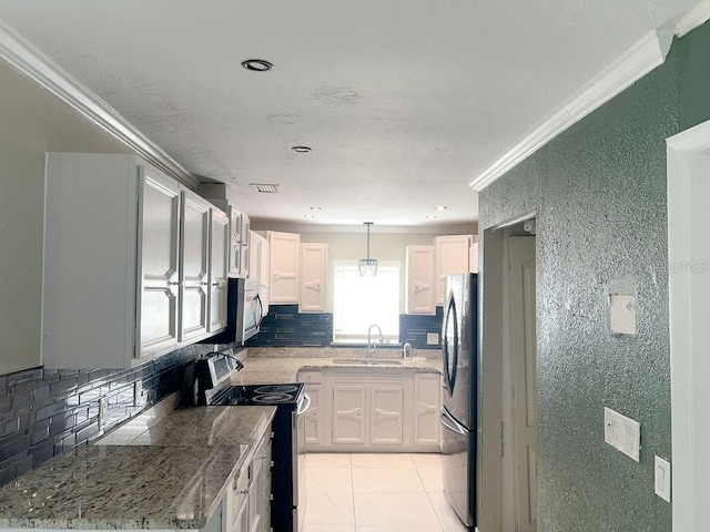 kitchen featuring ornamental molding, a sink, white cabinets, appliances with stainless steel finishes, and backsplash