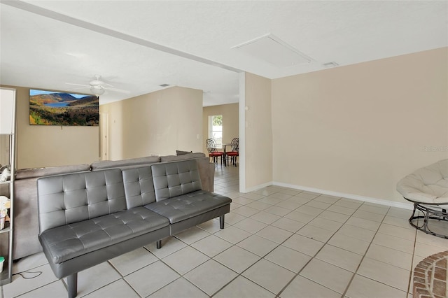 interior space with baseboards, light tile patterned flooring, and a ceiling fan