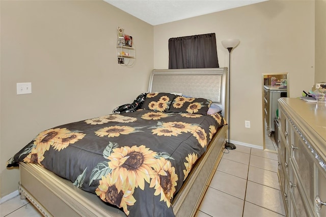 bedroom featuring baseboards and light tile patterned flooring