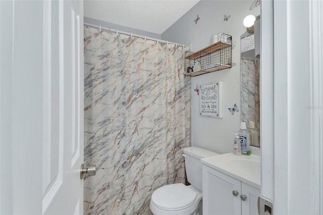 bathroom with toilet and vanity