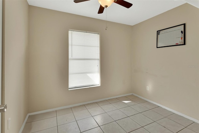 spare room with baseboards and a ceiling fan