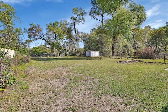 view of yard with a storage shed and an outdoor structure