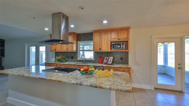 kitchen featuring a sink, french doors, appliances with stainless steel finishes, and island range hood