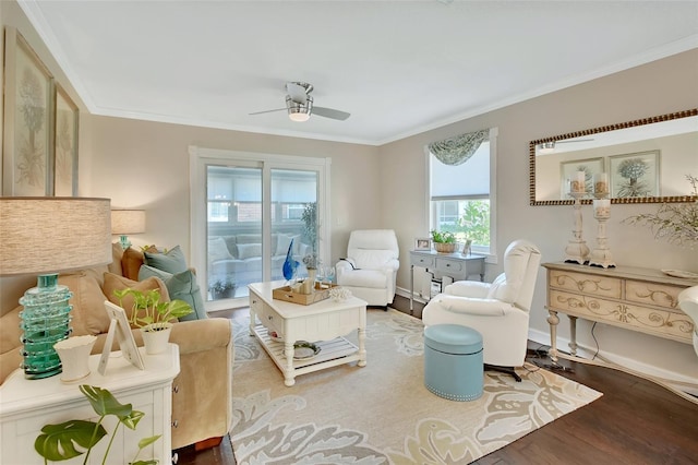 living area with a ceiling fan, crown molding, and wood finished floors