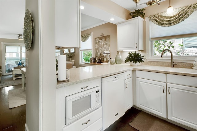 kitchen featuring a sink, white appliances, a healthy amount of sunlight, and white cabinetry