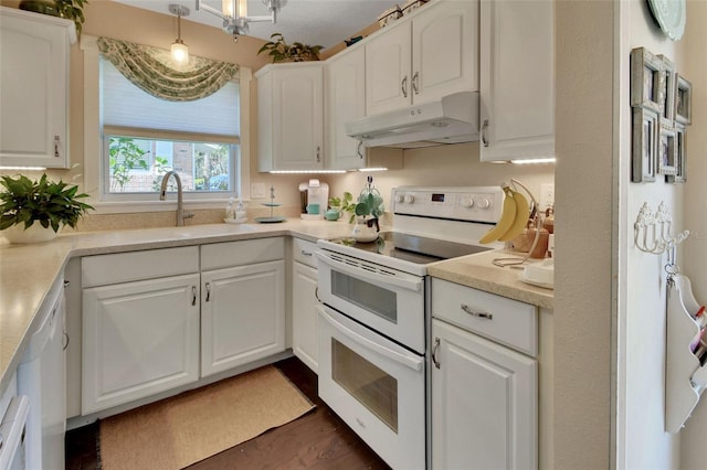 kitchen with under cabinet range hood, a sink, white appliances, white cabinets, and light countertops