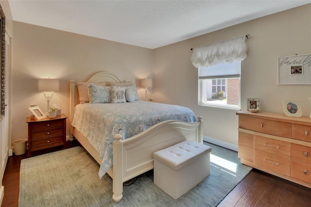 bedroom featuring dark wood-type flooring and baseboards