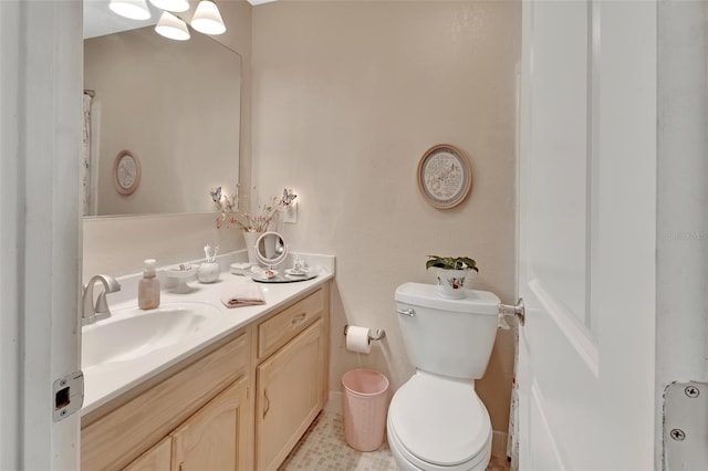 bathroom featuring toilet and vanity