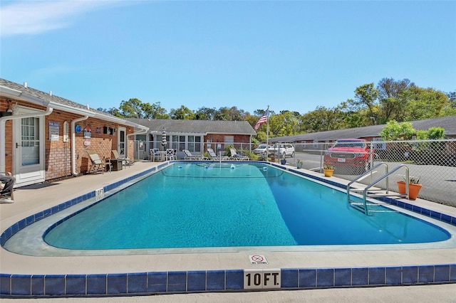 pool featuring a patio area and fence