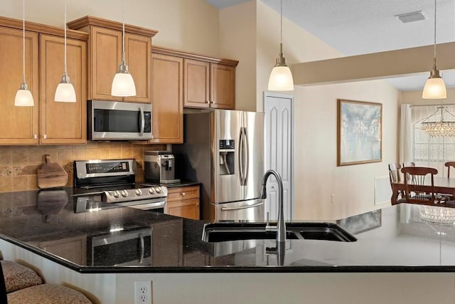 kitchen featuring a sink, decorative backsplash, brown cabinets, and stainless steel appliances