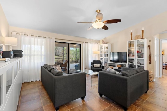 living area with tile patterned floors, lofted ceiling, arched walkways, and ceiling fan