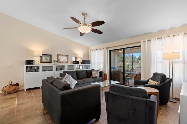 living area with tile patterned flooring, lofted ceiling, and a ceiling fan