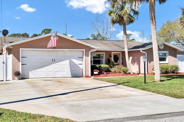 single story home featuring stucco siding, driveway, an attached garage, and a front lawn