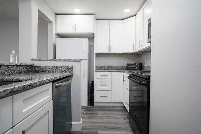 kitchen with dark wood-style floors, light stone countertops, a toaster, appliances with stainless steel finishes, and white cabinetry