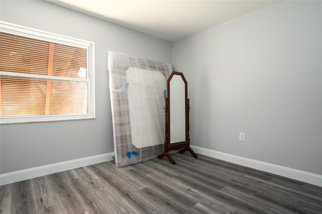 interior space featuring baseboards and wood finished floors