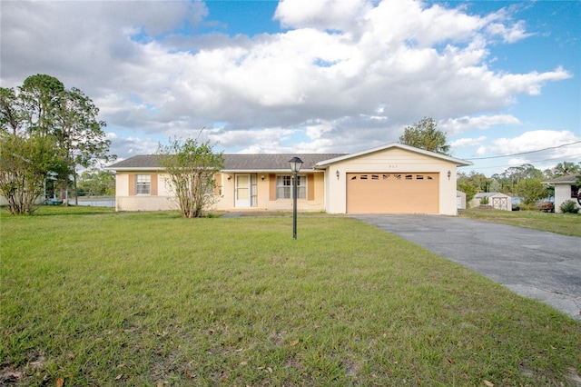 ranch-style house featuring stucco siding, a front yard, an attached garage, and driveway