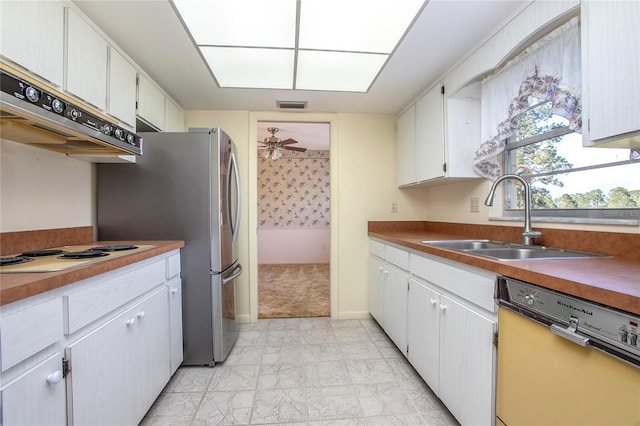 kitchen with visible vents, under cabinet range hood, white stovetop, dishwasher, and a sink