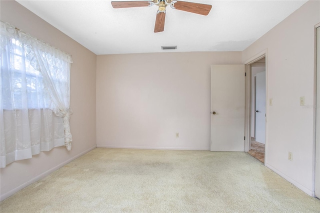 empty room featuring visible vents, baseboards, ceiling fan, and carpet floors