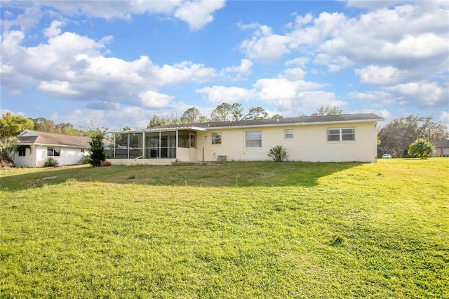 back of property featuring a yard and a sunroom