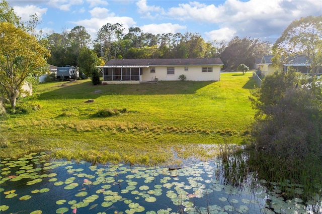 back of property featuring a lawn and a sunroom