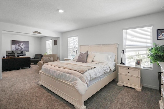 carpeted bedroom featuring a textured ceiling