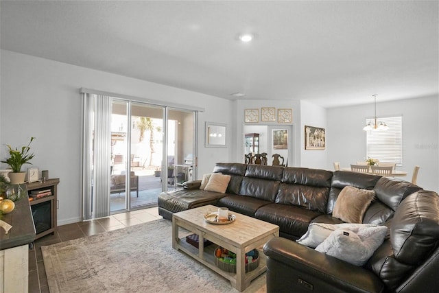 tiled living area featuring a notable chandelier