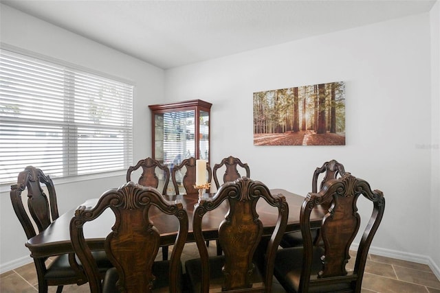 dining space with tile patterned flooring and baseboards