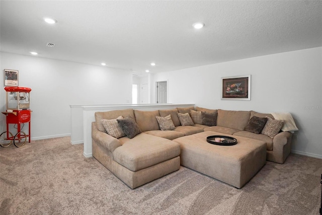 carpeted living room featuring recessed lighting, baseboards, and a textured ceiling