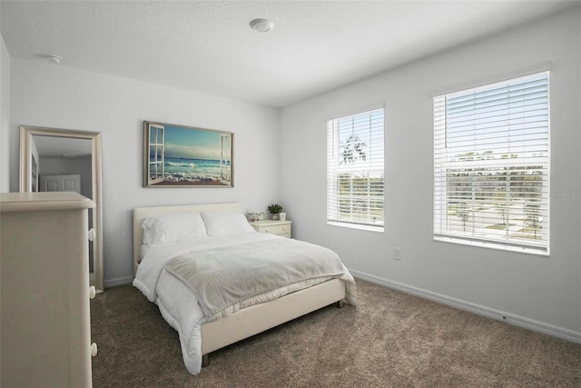 carpeted bedroom with baseboards