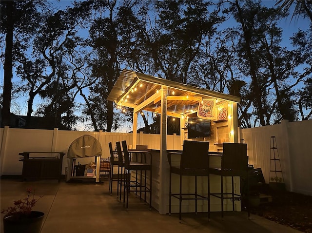 view of patio / terrace with a fenced backyard and outdoor dry bar