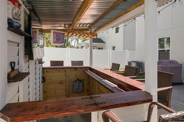 view of patio / terrace featuring central AC unit, fence, and a grill