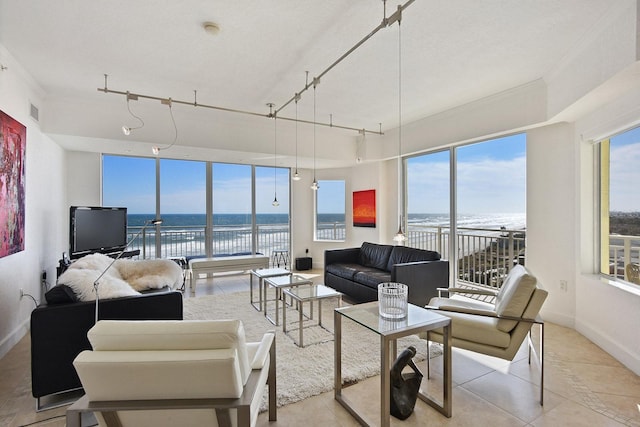 living area featuring light tile patterned floors, visible vents, rail lighting, and baseboards