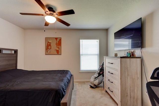 bedroom featuring baseboards, light carpet, and ceiling fan