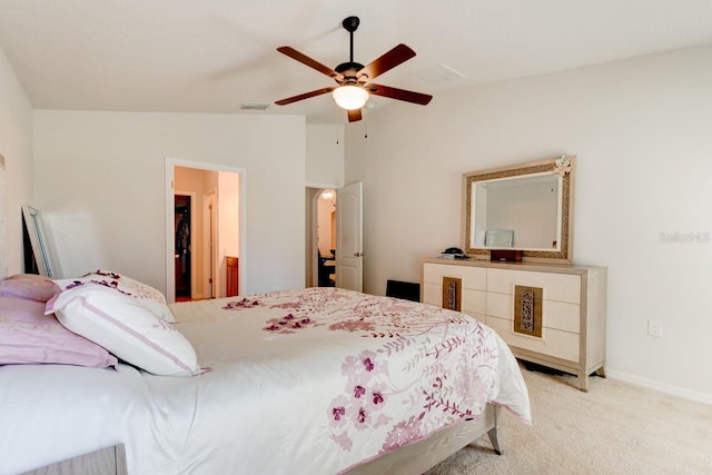 bedroom with visible vents, baseboards, light colored carpet, vaulted ceiling, and a ceiling fan