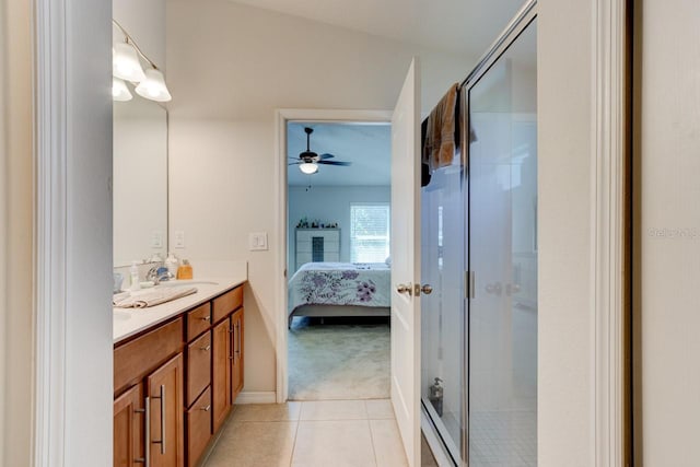 full bathroom featuring tile patterned floors, double vanity, a stall shower, and ensuite bathroom