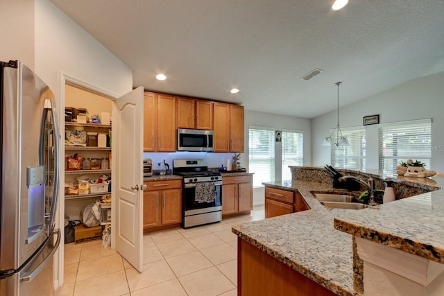 kitchen with visible vents, a sink, stainless steel appliances, light tile patterned floors, and lofted ceiling