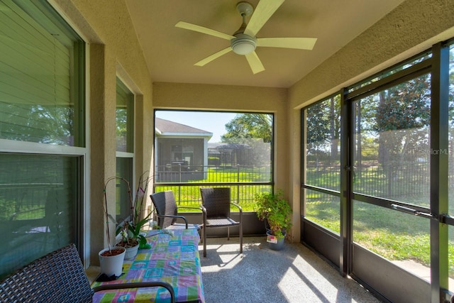 sunroom featuring a ceiling fan and a healthy amount of sunlight