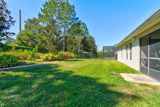 view of yard featuring a lanai and a fenced backyard