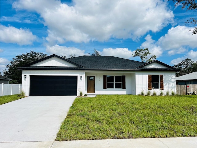 ranch-style house featuring fence, roof with shingles, concrete driveway, a front yard, and a garage