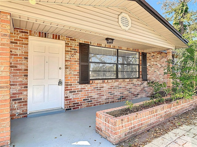 entrance to property with brick siding